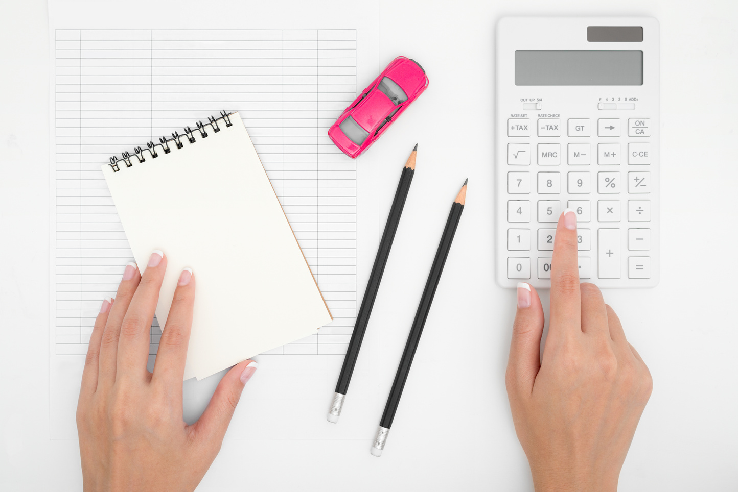 Woman hand calculating car expenses payments costs with paper notes, pencil, calculator, payments table,dollar money and toy car. Financial and Installment payment concept.